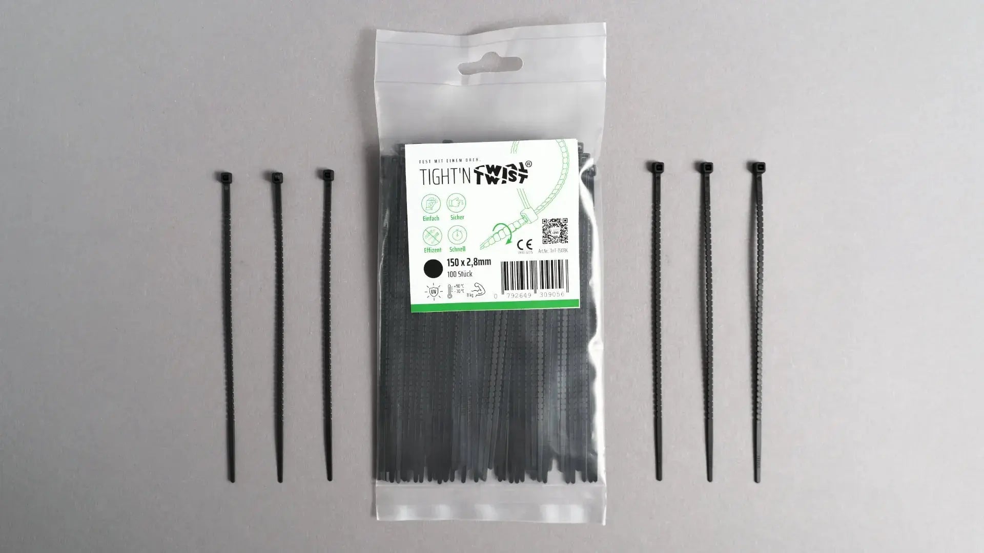 Ein Tight'n Twist Kabelbinder 150x2p8 mm in Schwarz liegt neben der Originalverpackung – Detailansicht des innovativen Designs