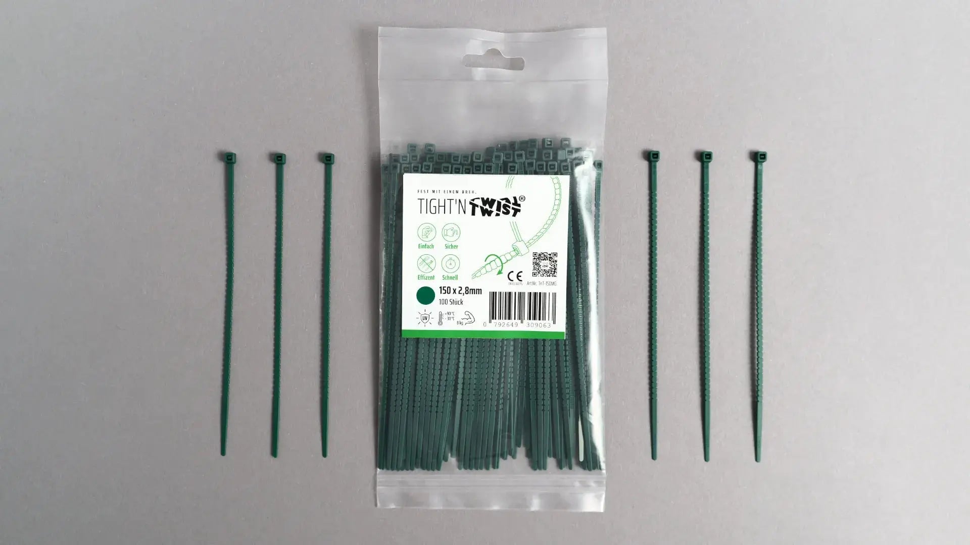 Ein Tight'n Twist Kabelbinder 150x2p8 mm in Moosgrün liegt neben der Originalverpackung – Detailansicht des innovativen Designs