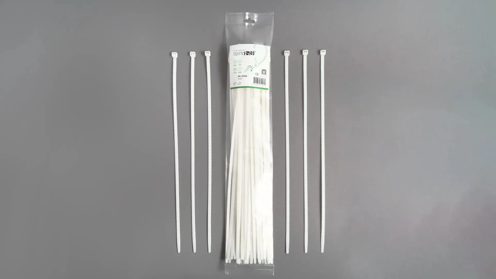 Ein Tight'n Twist Kabelbinder 504x8 mm in Weiß liegt neben der Originalverpackung – Detailansicht des innovativen Designs