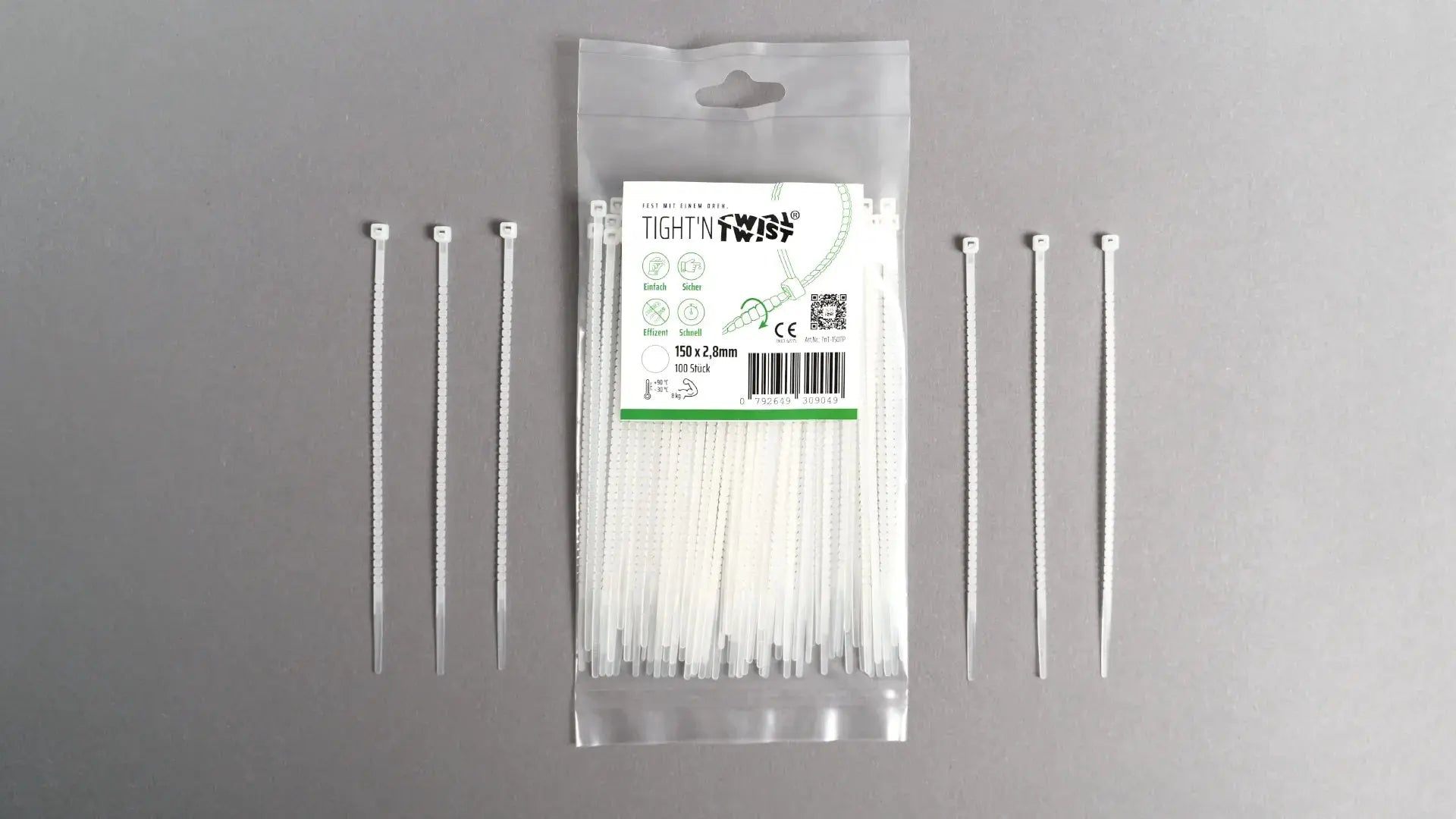 Ein Tight'n Twist Kabelbinder 150x2p8 mm in Weiß liegt neben der Originalverpackung – Detailansicht des innovativen Designs