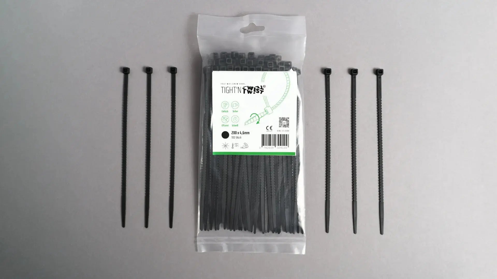 Ein Tight'n Twist Kabelbinder 200x4p6 mm in Schwarz liegt neben der Originalverpackung – Detailansicht des innovativen Designs
