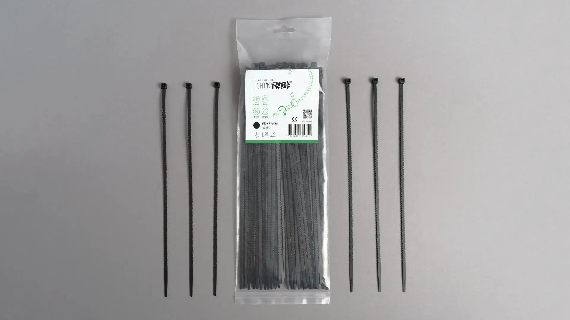 Ein Tight'n Twist Kabelbinder 300x4p6 mm in Schwarz liegt neben der Originalverpackung – Detailansicht des innovativen Designs