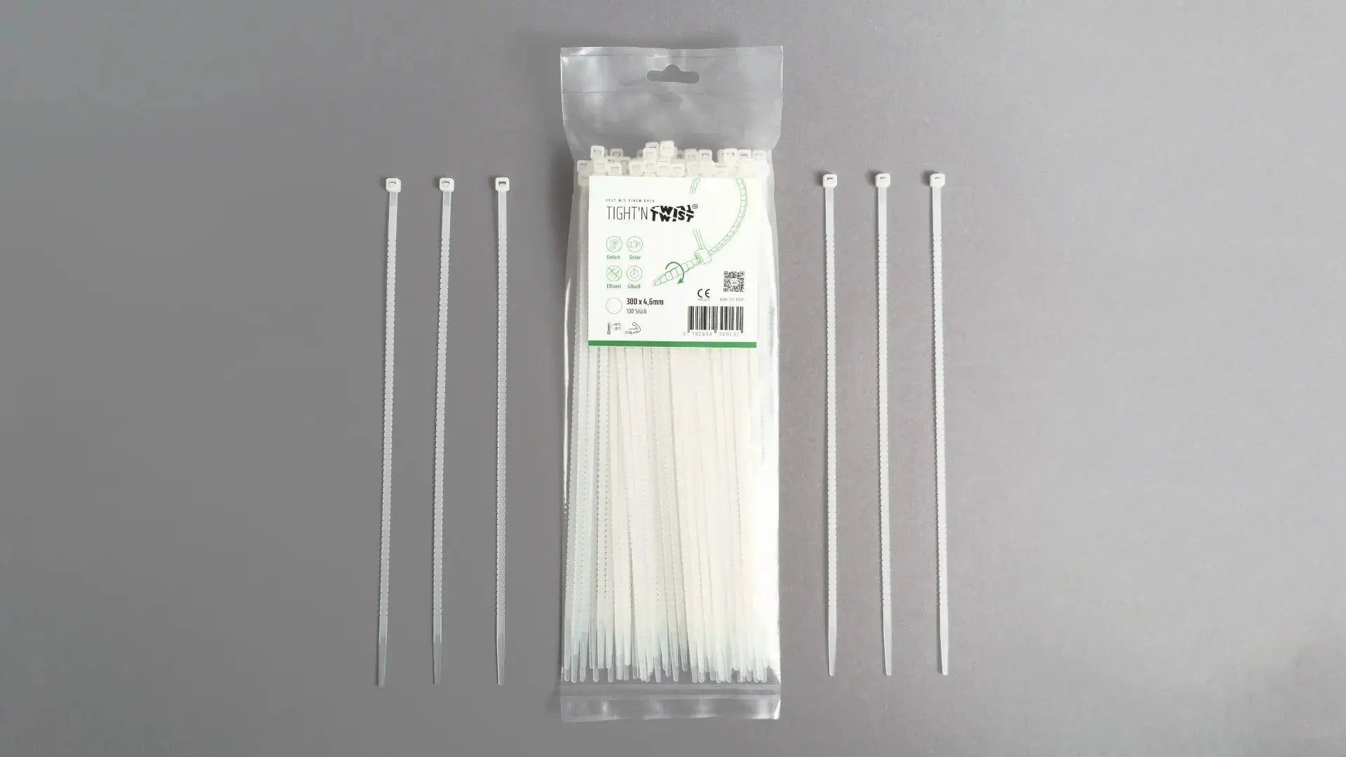 Ein Tight'n Twist Kabelbinder 300x4p6 mm in Weiß liegt neben der Originalverpackung – Detailansicht des innovativen Designs
