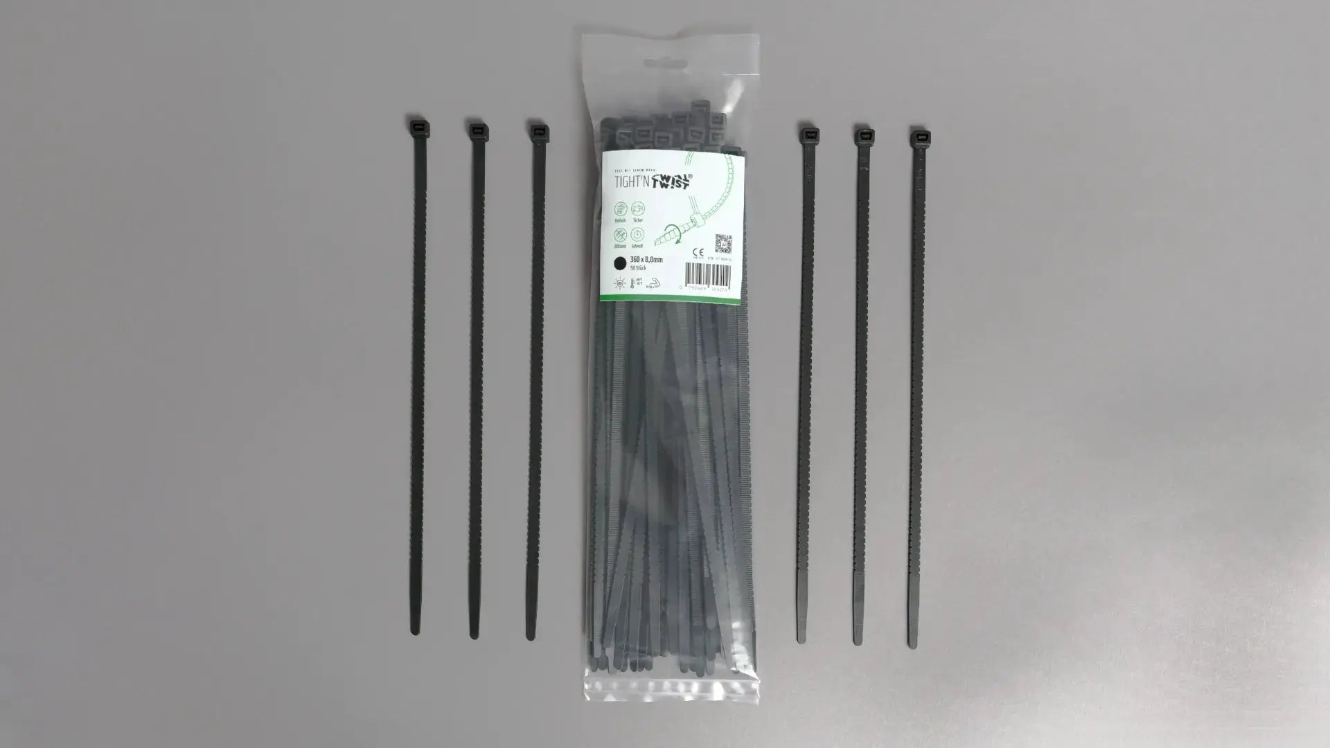 Ein Tight'n Twist Kabelbinder 360x8 mm in Schwarz liegt neben der Originalverpackung – Detailansicht des innovativen Designs