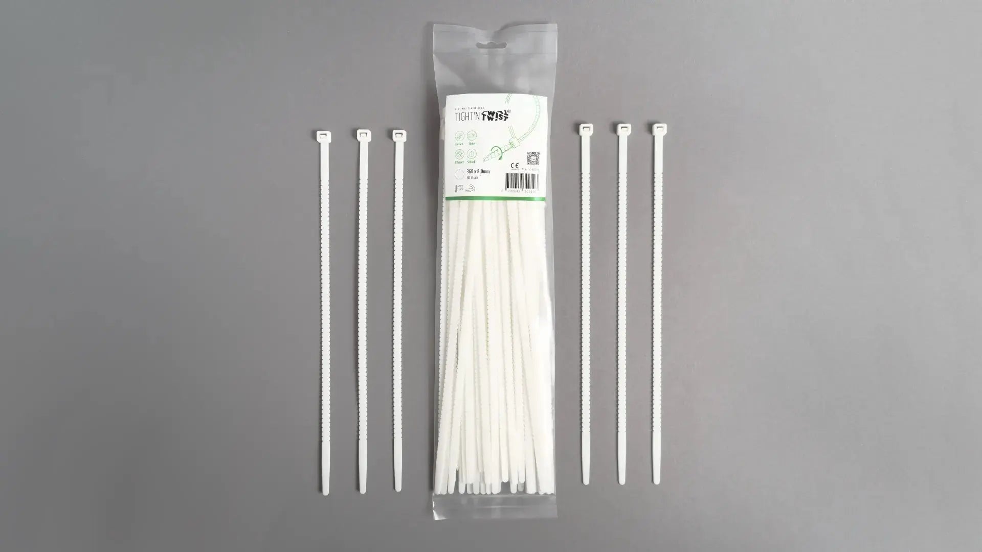 Ein Tight'n Twist Kabelbinder 360x8 mm in Weiß liegt neben der Originalverpackung – Detailansicht des innovativen Designs